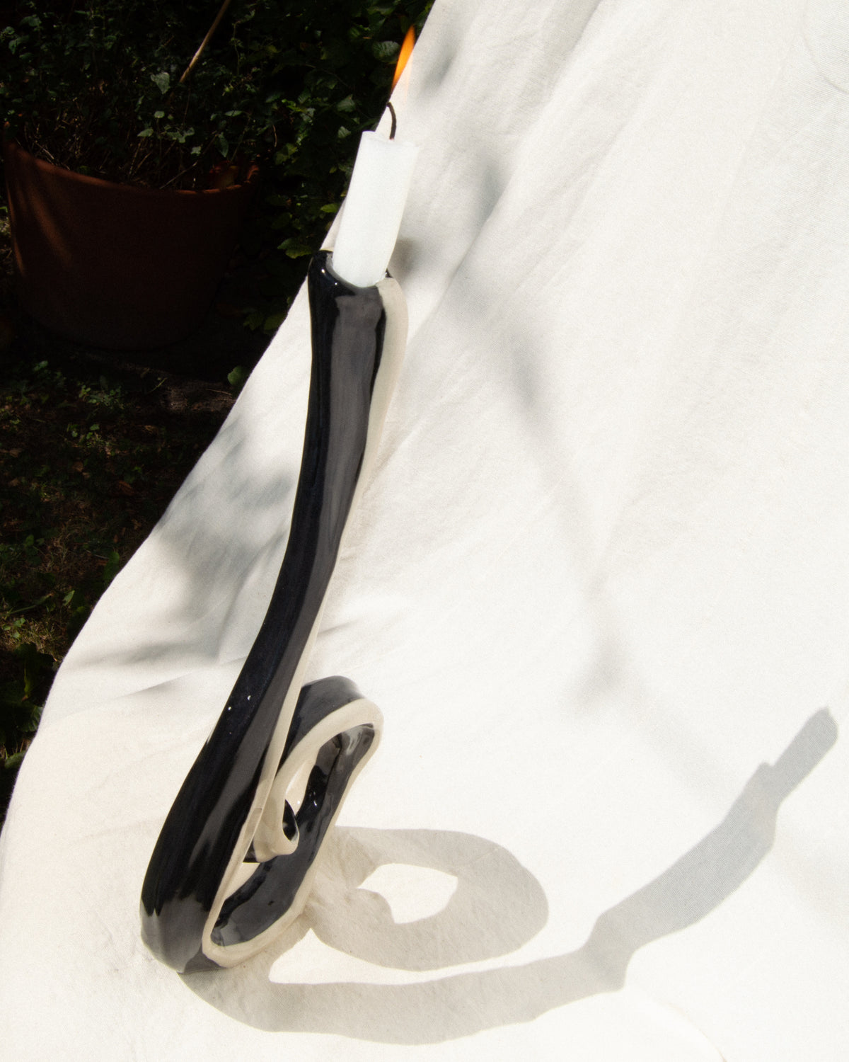 Candle holder – hand-painted black and off-white stoneware candleholder and vase