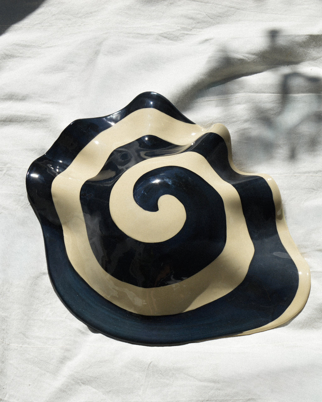 Spiral nautilus – glossy hand-painted stoneware wall piece with a spiral motif