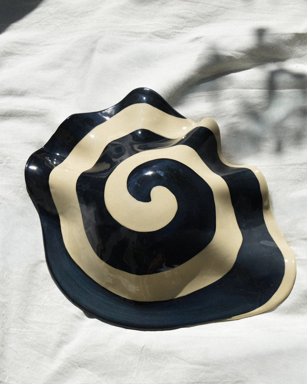 Spiral nautilus – glossy hand-painted stoneware wall piece with a spiral motif